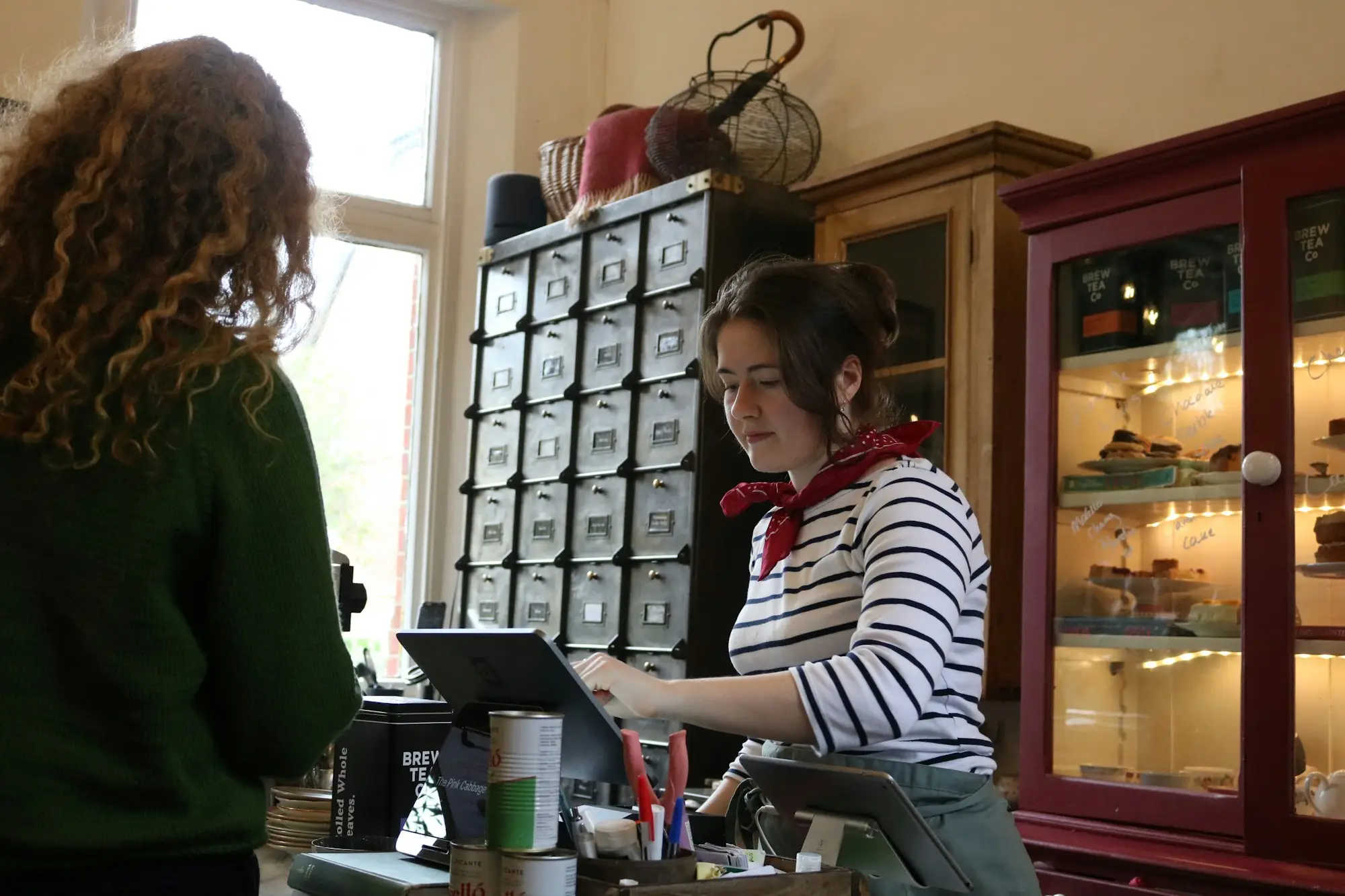 Café owner serving a customer at the counter