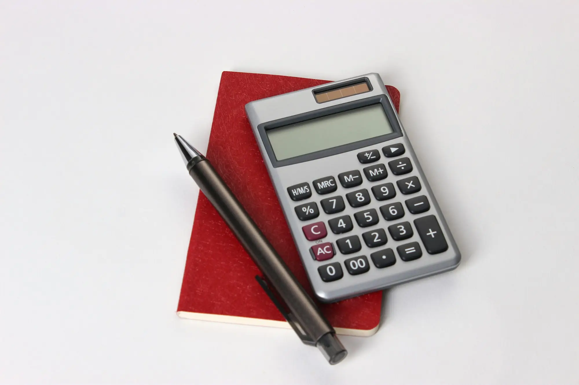 Calculator and pen ready for cash flow planning